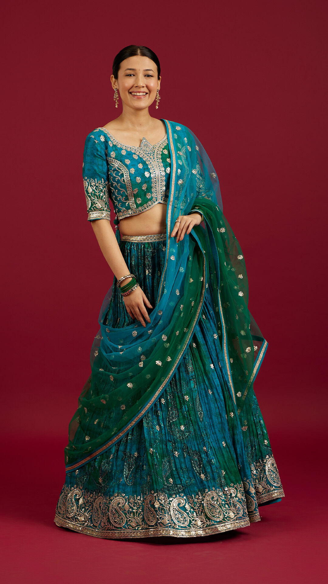 Woman wearing a blue printed lehenga for a wedding photoshoot